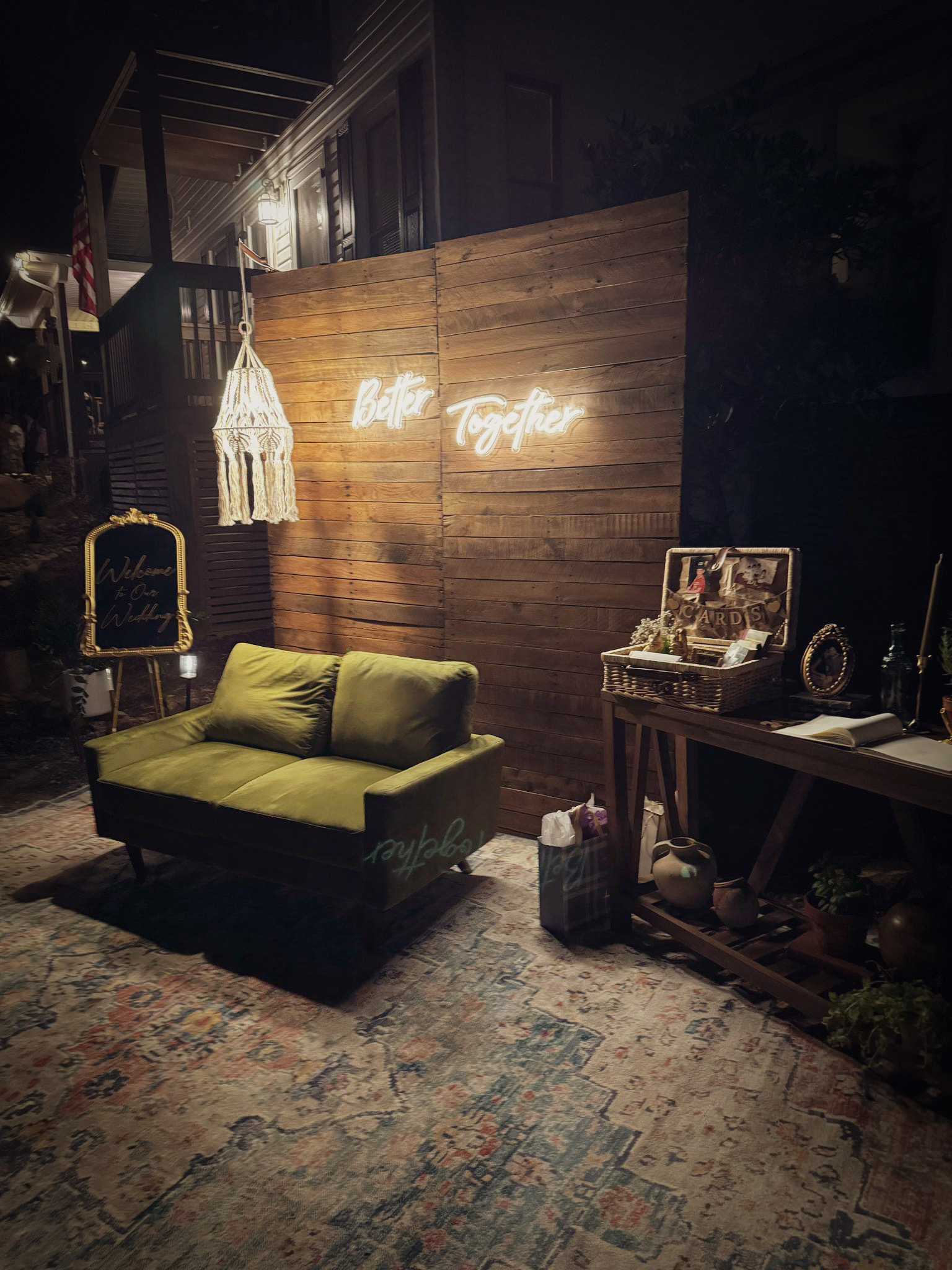 Vintage photo booth area with welcome decor at Secluded Ridge